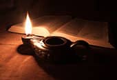 A oil lamp lights the scriptures