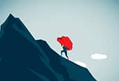 Carrying heavy boulder up mountain