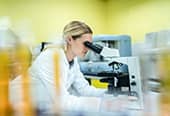Woman looking through microscope
