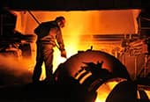 A man works in a steel mill