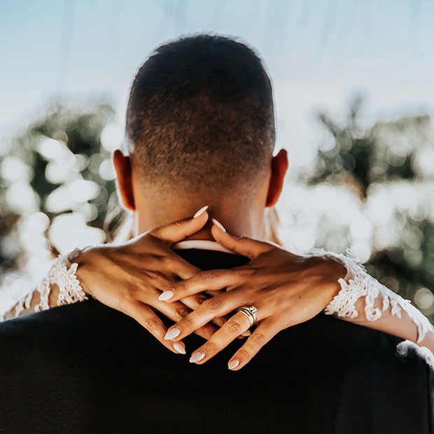 A bride and groom embracing on their wedding day, excited their new life together.