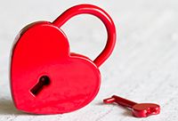 A red, heart-shaped lock and a red, heart-shaped key