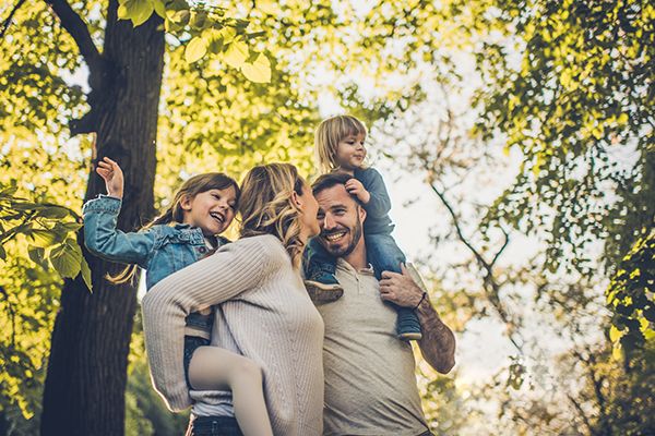 A young family walking together in the woods