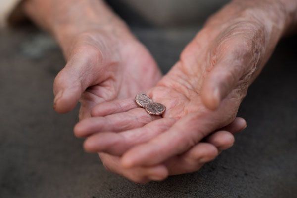 Woman holding two coins
